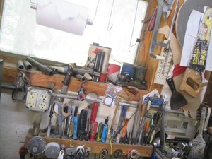Screwdrivers, taps, files, hand saw, hacksaw, hand planer and other tools on wall