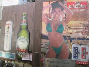 Winchester ammunition thermometer, Moosehead tin sign and Old Milwaukee bathing edition wall poster