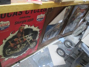 Variety of automotive and beer posters all from the swimsuit edition