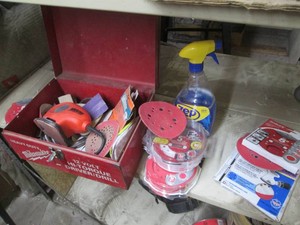 Black and Decker mouse sander and a variety of sanding pads in metal Milwaukee case