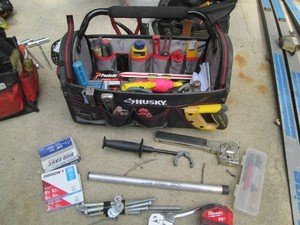 Husky open top hard frame tool bag loaded with cutting tools, tacking supplies and more including Milwaukee and Dewalt