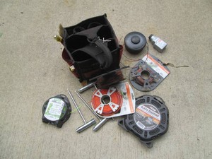 Husky open tip tool bag loaded with trimmer line and other weed eater accessories