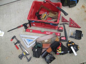 Milwaukee Packout open top crate containing a wide variety of measuring tools and supplies also Milwaukee with other brands mixed in