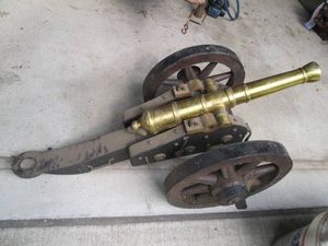 Vintage Black powder cannon with wood frame and wheels and heavy brass exit chamber 16in wheels. unit approx 41in long