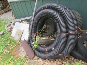 Corregated drain tubing and snow shovel