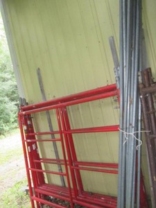 Heavy duty red tubular metal scaffolding unit unassembled
