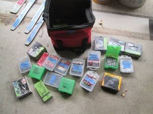 Milwaukee soft sided zip tool bag full of assorted fasteners and construction hardware