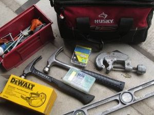 Husky soft side zip tool bag with pipe cutter, hammers, fasteners and more