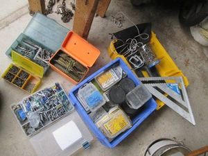 Hardware organizers and trays full of assorted fasteners, construction hardware and supplies