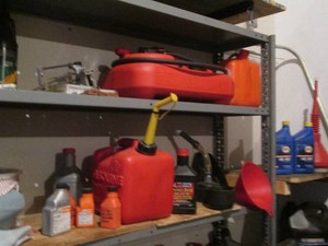 Variety of chainsaw oil, gas cans and other fluids