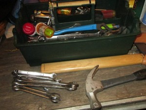 Open top tool tray with Craftsman wrenches, hatchet and assorted tools