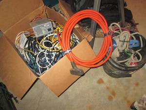 Box of cable wire, heavy duty extension cord, ratchet straps and bungee cords
