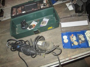 Pair of Dremel tools and plastic toolbox of Dremel supplies and accessories