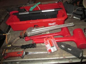 Milwaukee Packout top handle tool tray full of assorted metal files, chisels, small sledgehammer and other hand tools