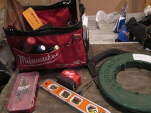 Milwaukee top handle tool bag with a variety of electrical, measuring and cutting tools and supplies plus GreenLee wire fish tape