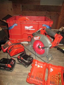 Milwaukee Packout open top crate, Milwaukee fuel m18 circular saw, saw blades, m12m18 charger, 2-18v batteries and titanium drill bits