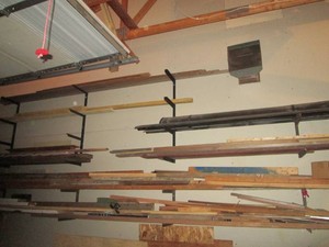 All wood and assorted lumber on garage wall