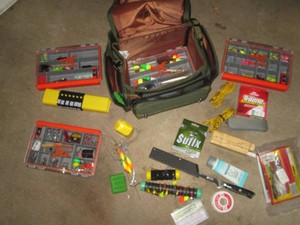 Soft sided tackle organizer loaded with a huge variety of assorted tackle, bobbers, lures, sinkers, fishing line and more