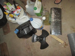 Metal boat anchor, household cleaners and bucket of JB WELD, caulking and various other supplies