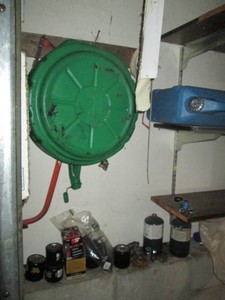 Variety of drain oil pans, Portable water jug, assortment of automotive chemicals and more