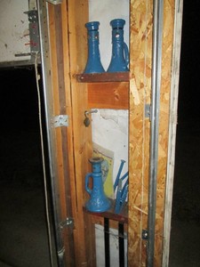 Trio of blue metal cylinder style jack stands