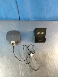 Bose SoundLink Micro Bluetooth speaker and  black acrylic charging stand and speaker