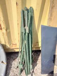 Bundle of green-painted steel U-channel fence posts (