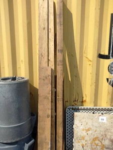 Several long pieces of raw construction lumber