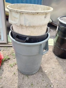 Three heavy-duty commercial round plastic utility and trash containers