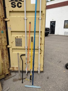 Collection of various long-handled tools and equipment
