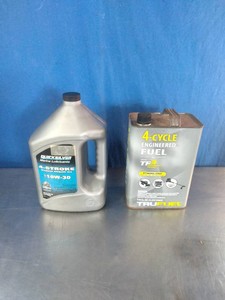 Quicksilver 4-Stroke 10W-30 Marine Engine Oil and a metal can of TruFuel 4-Cycle Engineered Fuel