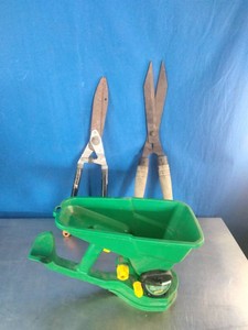 Portable hand-crank broadcast spreader and two pairs of traditional shearing tools