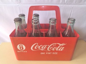 Vintage Coca-Cola bottles and Carrier