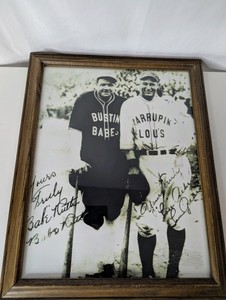 Framed commemorative photographic reproduction print featuring legendary New York Yankees players Babe Ruth and Lou Gehrig in their 1927 barnstorming tour uniforms