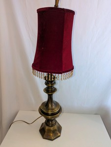 Vintage table lamp heavy, multi-tiered antique brass base, burgundy red velour shade adorned with beaded fringe