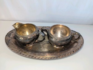Vintage silver-plated creamer, sugar bowl, and matching small serving tray set