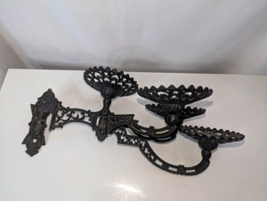 Antique Victorian-style cast iron swing-arm wall bracket candle stick holder
