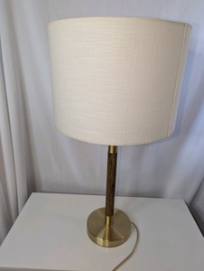 Mid-century modern table lamp- warm wood stem accent with an antique brass-finished metal base