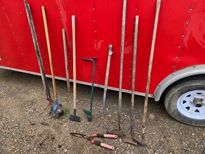 Garden tools including hoes, pitchforks, and shears
