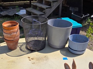 Stack of Terracotta Pots, Wire Mesh Trash Can, and Plastic Plant Pots