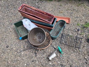 Plastic Planters and Gardening Tools including Various Pots, Seeder Tool, and Wire Racks