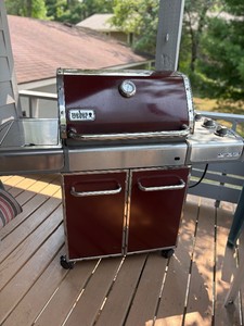 Red Weber grill with side burner.