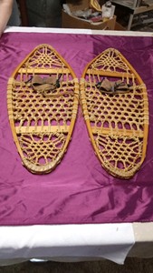 Vintage snow shoes of wood, raw hide,and leather