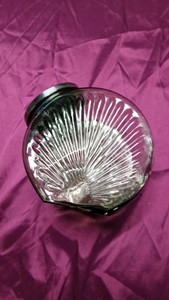 Green glass kitchen canister with embossed fan design and hinged metal lid