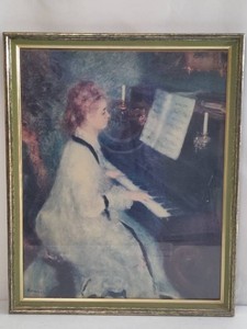 Woman at the Piano Pierre Auguste Renoir Framed Print
