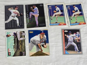 Lot of 7 Greg Maddux Baseball Cards featuring Topps and Fleer brands with Chicago Cubs and Atlanta Braves teams.