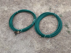 Two Garden Hoses. Estimated 50 Long