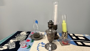 candlestick holders, candles, and vintage silver-plated oil or kerosene lamp