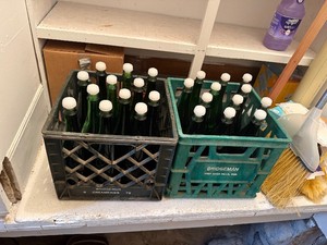 2 Dairy Totes of Green Glass Wine Bottles with Caps (24 total)