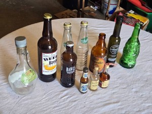 Lot of Empty Bottles and Containers Including Nature��s Beer Bread Bottle, BAWLS Guarana Root Beer Bottle, Whistler Classic Soda Bottles, and Old Milwaukee Beer Bottle